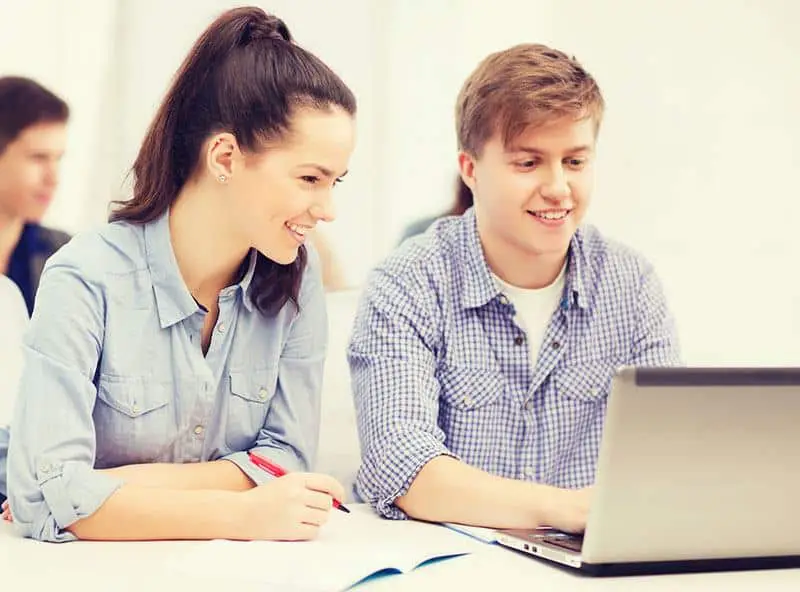 a teacher and his student working together on a computer