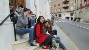 students on the street seat on a staircase