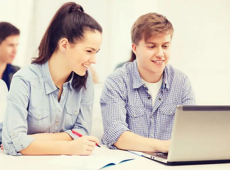 a teacher and his student working together on a computer